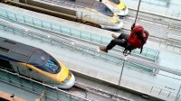 Jonathan Foyle abseils down to the platforms of St Pancras Station in 'Climbing Great Buildings'